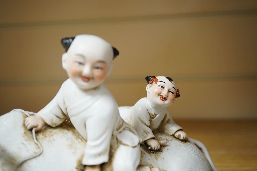 A Chinese Shiwan pottery pod shaped 'frog' vase - 32cm high including stand and a biscuit buffalo group (2)